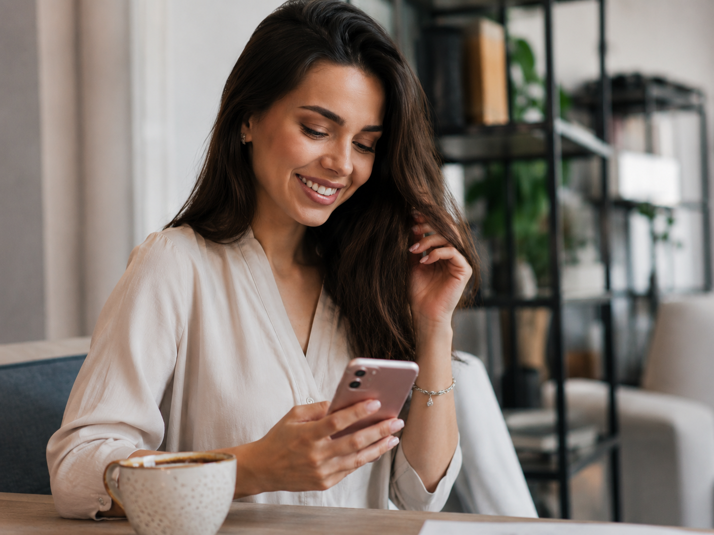 Happy axplusb customer using the app on her phone
